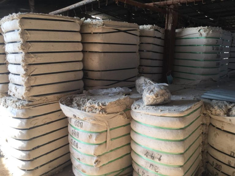 Bales of cotton linters stacked in storage, showcasing the raw material's light, fluffy texture before being processed for industrial use.