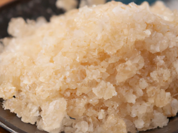 Close-up view of VHP sugar crystals, showcasing their golden-brown color and coarse texture, indicative of the high sucrose content before further refining.