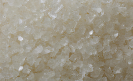 Raw sugar, showcasing its color and granulation size.